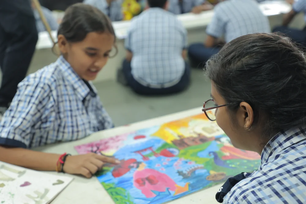 A student painting at the art room table
