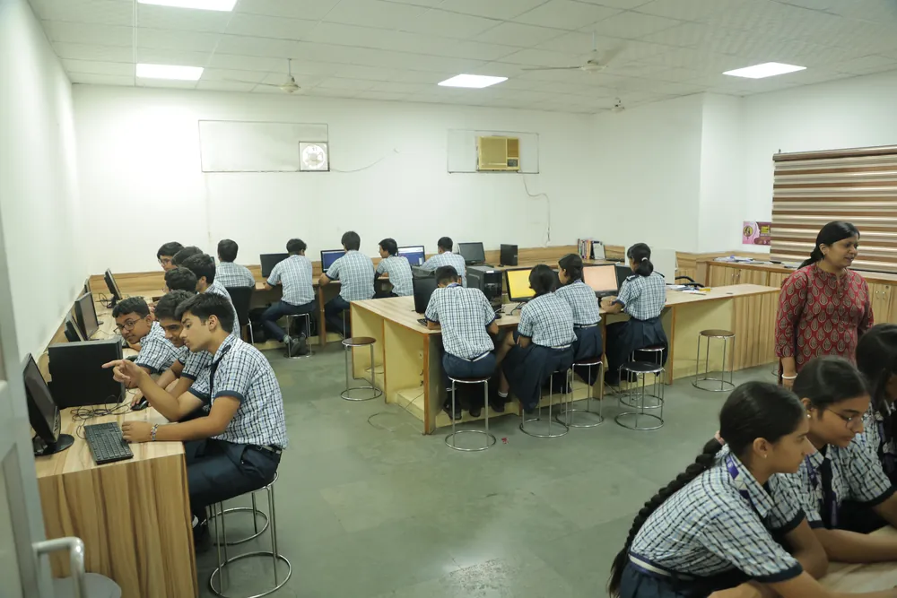 Senior students at work in the computer lab with their teacher