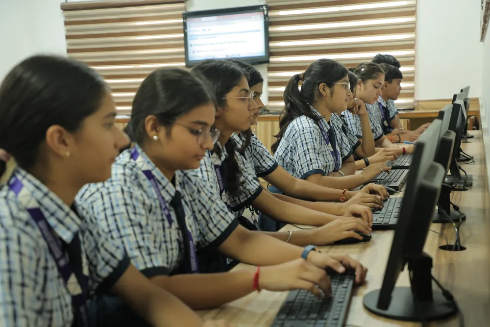 Senior students typing at a row of computers