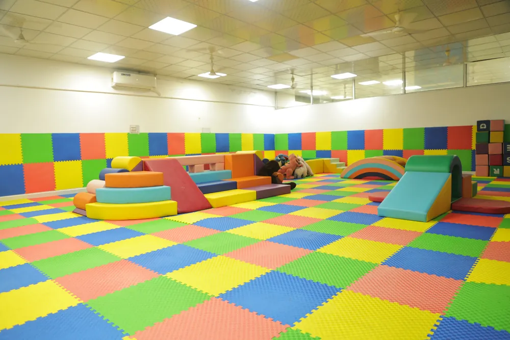 Foam blocks, ramps and tunnels on the soft-play floor