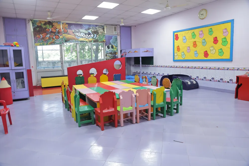 A pre-primary classroom with child-sized tables and chairs