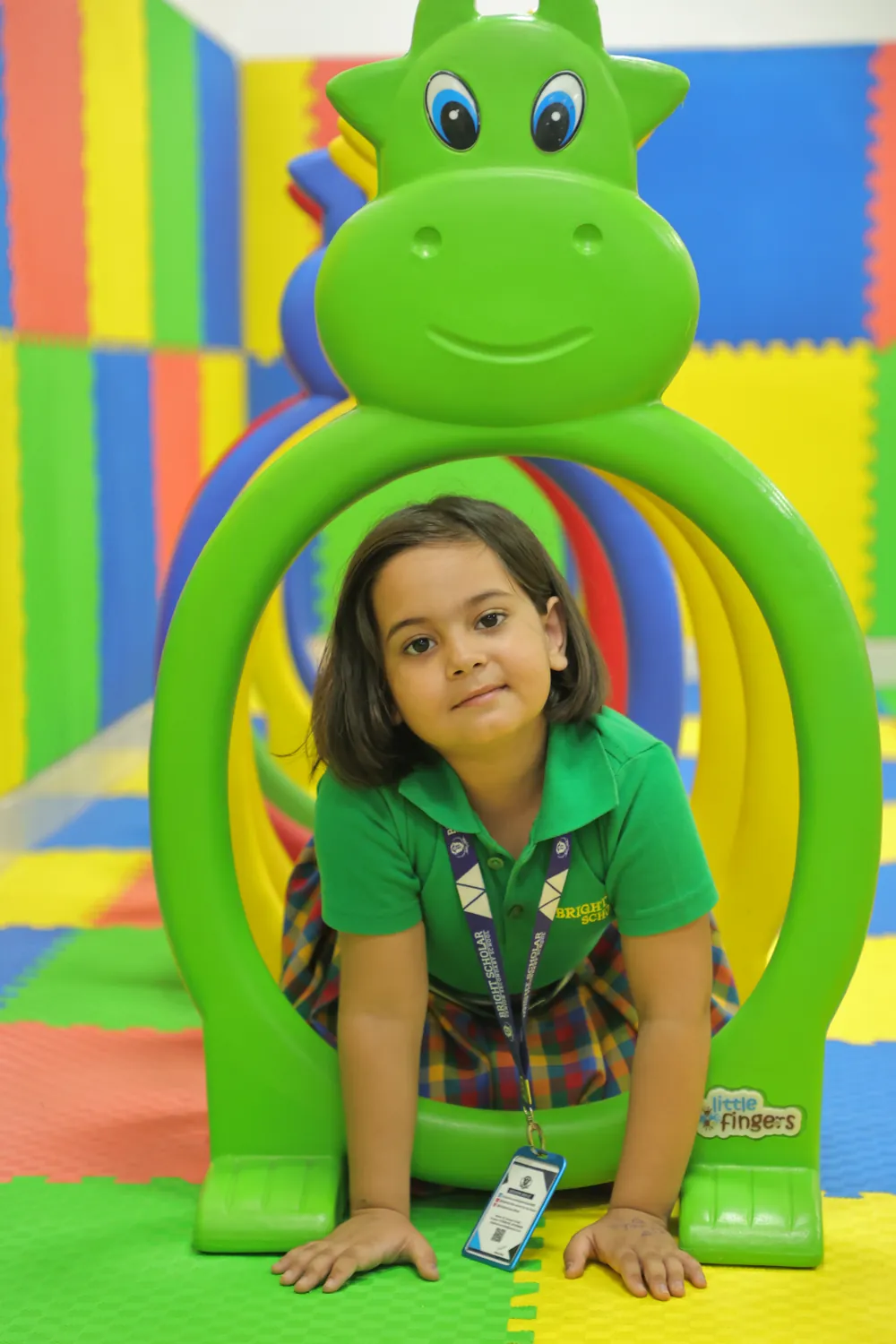 A child peeping through a play ring