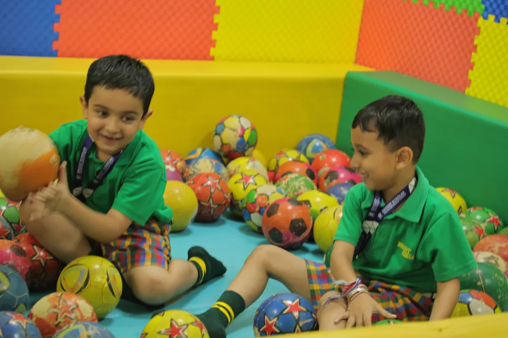 Two boys in the ball pit