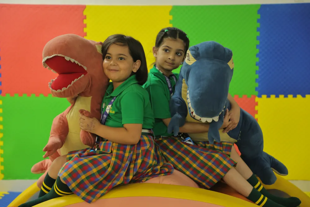 Two children with the soft dinosaurs