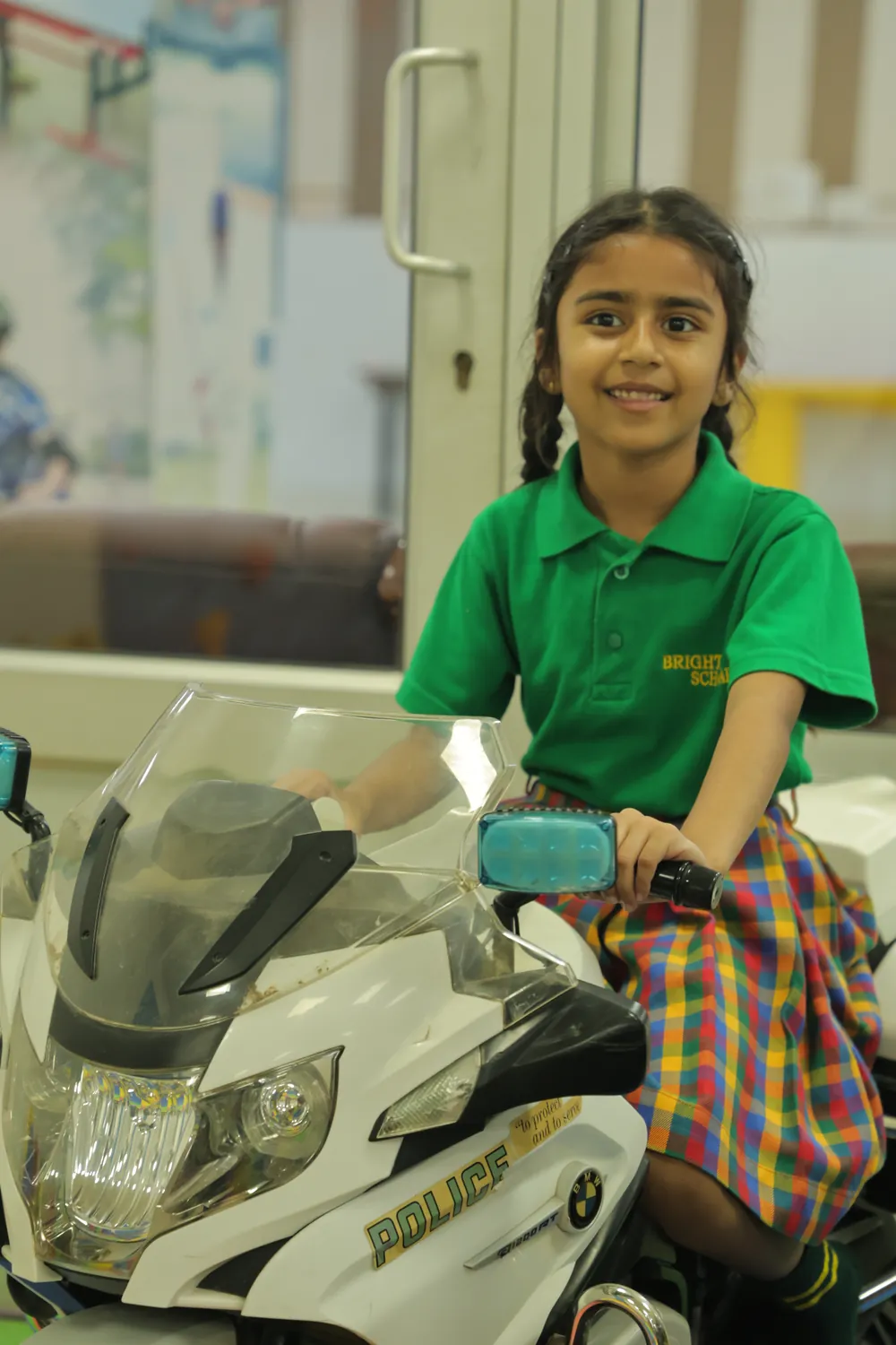A girl on a ride-on bike