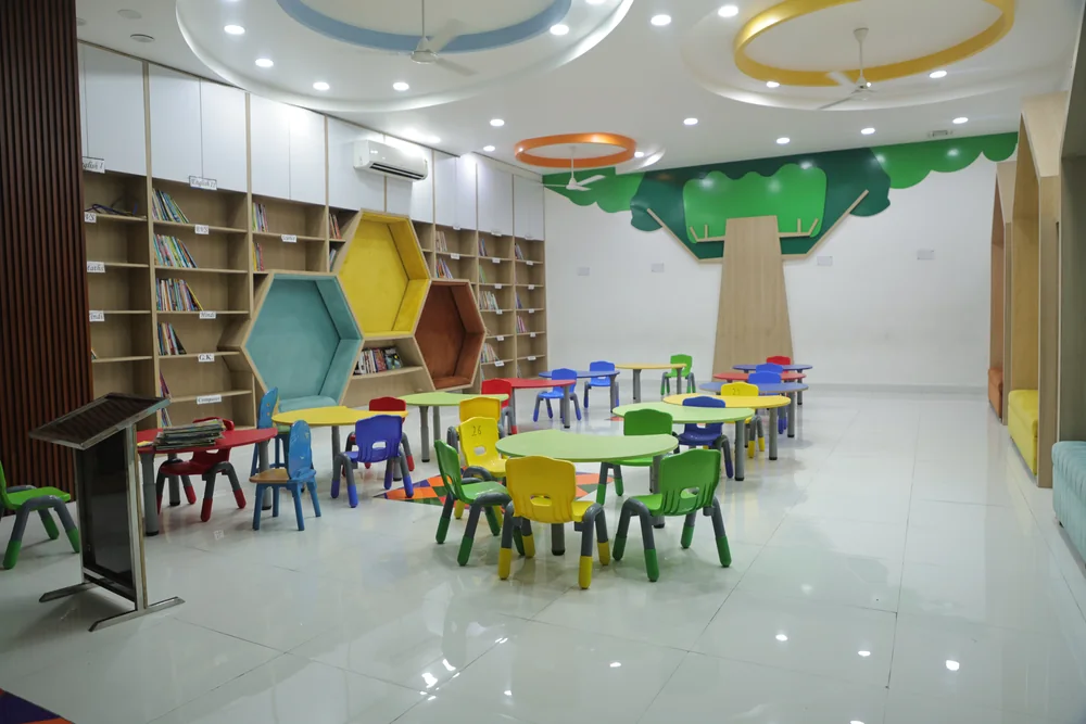 Low shelves and bright tables in the Library for Kids