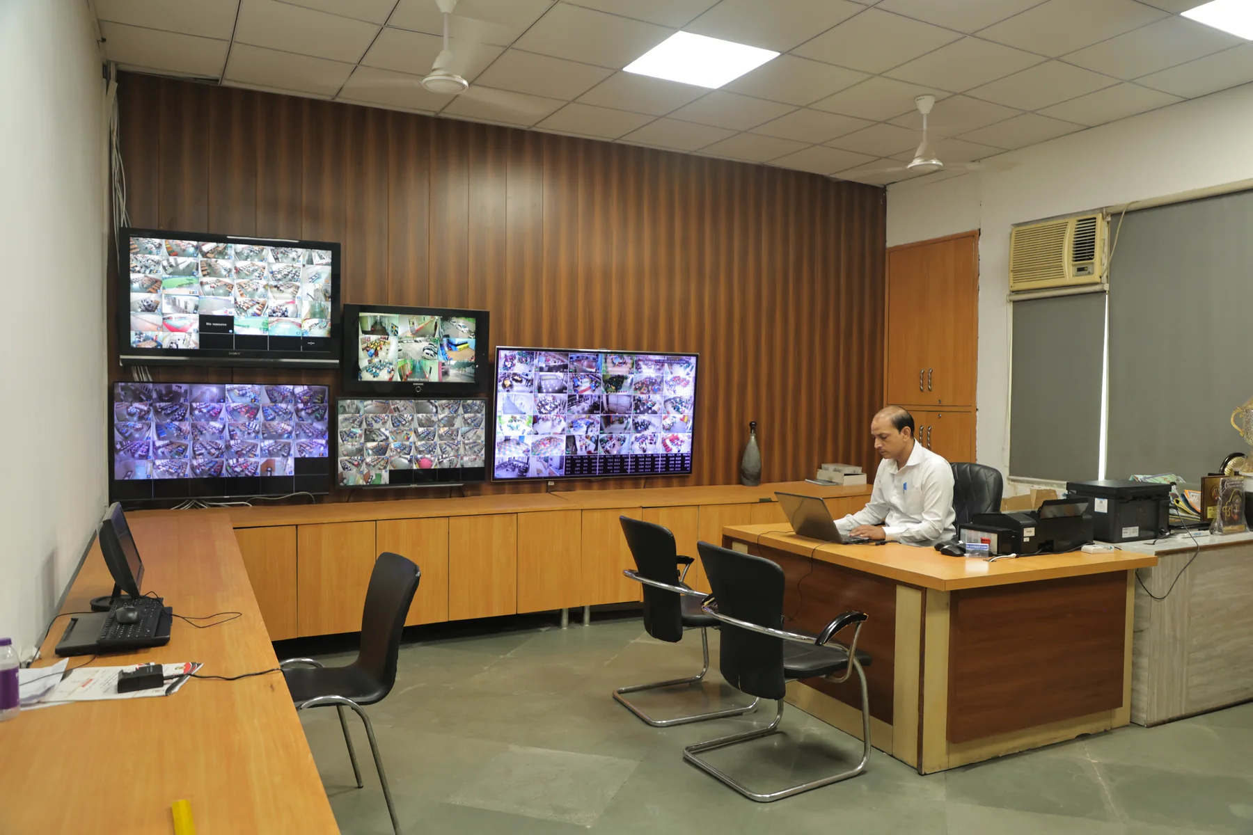 The CCTV control room, every camera on the wall of screens