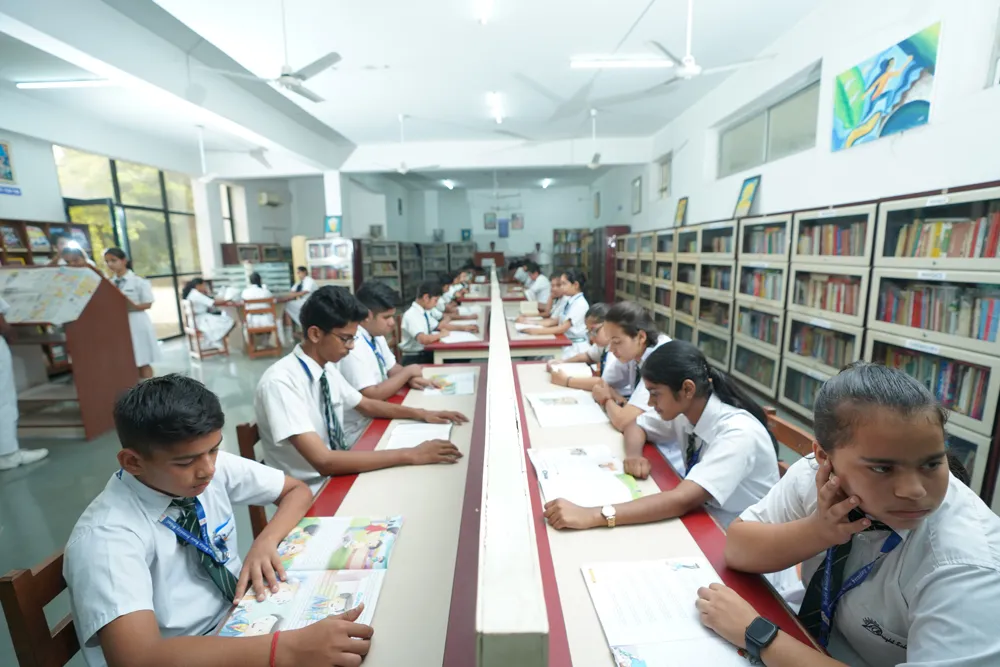 Students studying at library tables