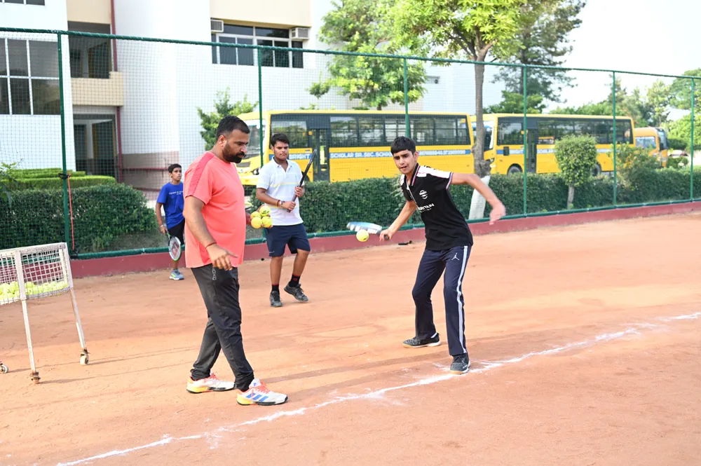 Coaches and students on the lawn tennis court