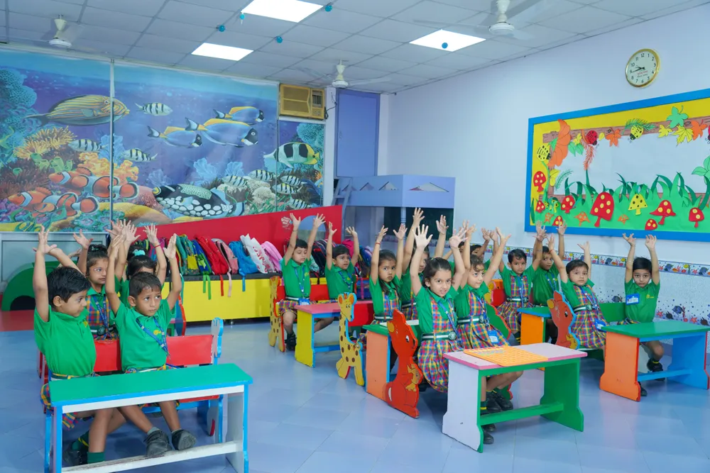 Students raising hands in a bright classroom