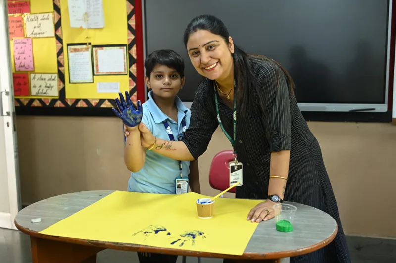 A teacher and a young student at an activity table