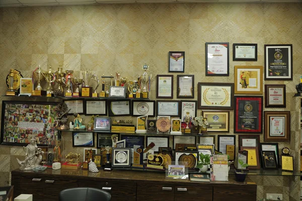 The shelf of trophies and citations in the Principal’s office